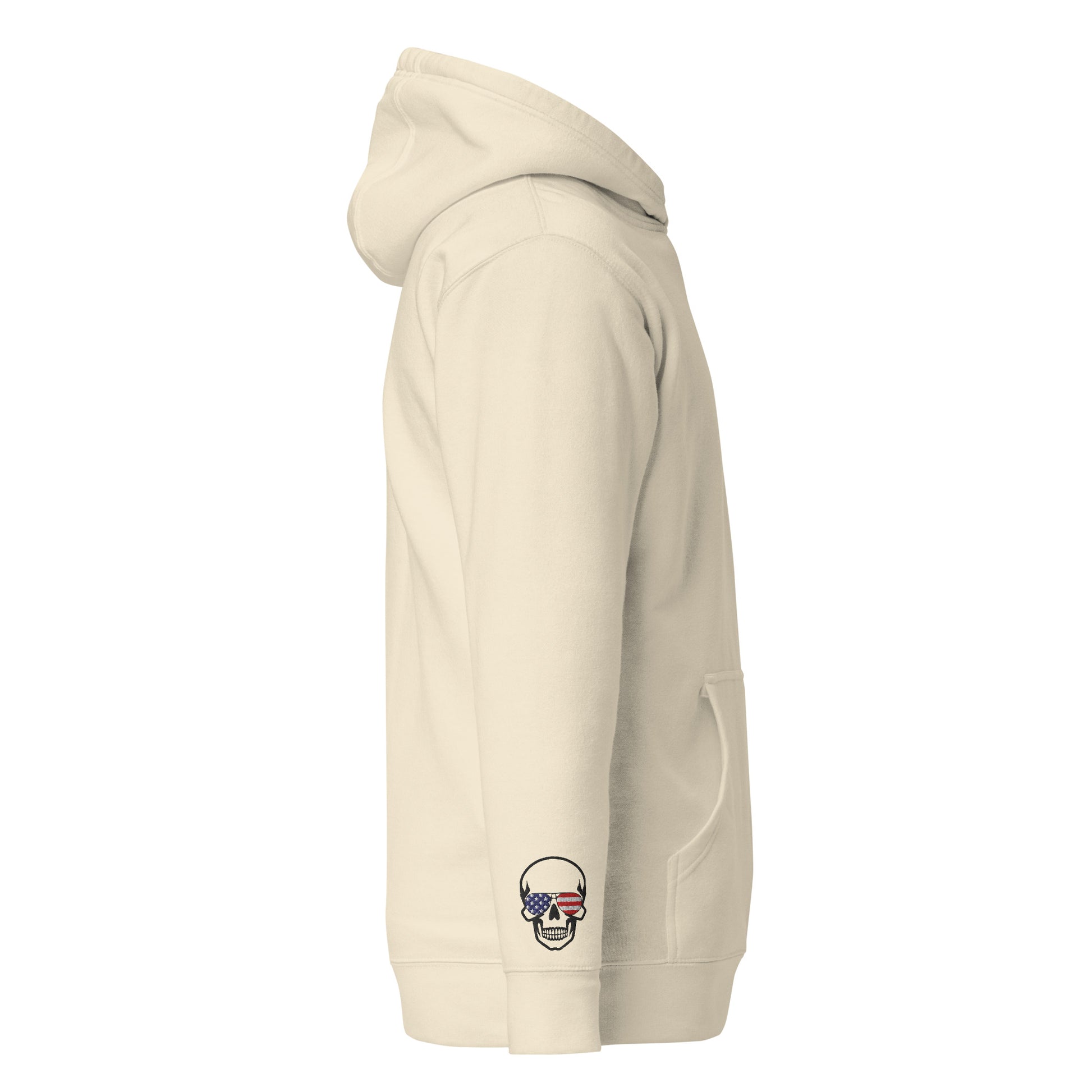Left side view of oatmeal hoodie, pouch pocket shown, skull-wearing-USA-flag cuff patch