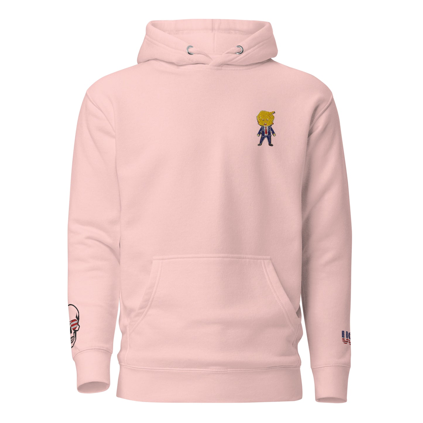 Front view of light pink hoodie with embroidered cartoon Happy Trump on chest, skull US flag on sleeve