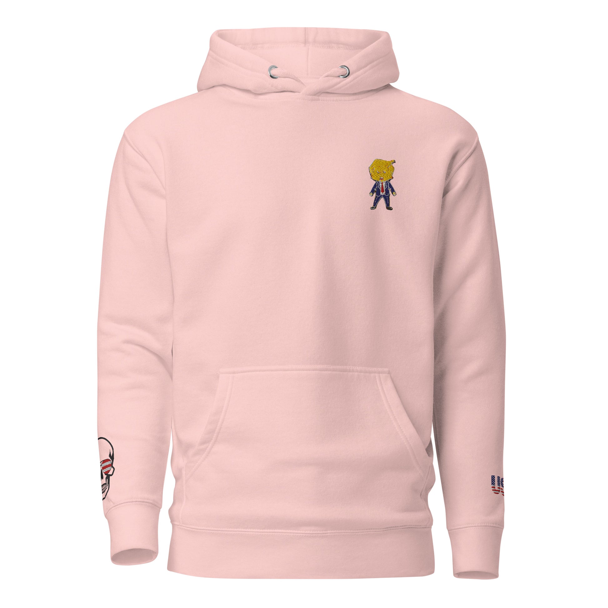Front view of light pink hoodie with embroidered cartoon Happy Trump on chest, skull US flag on sleeve