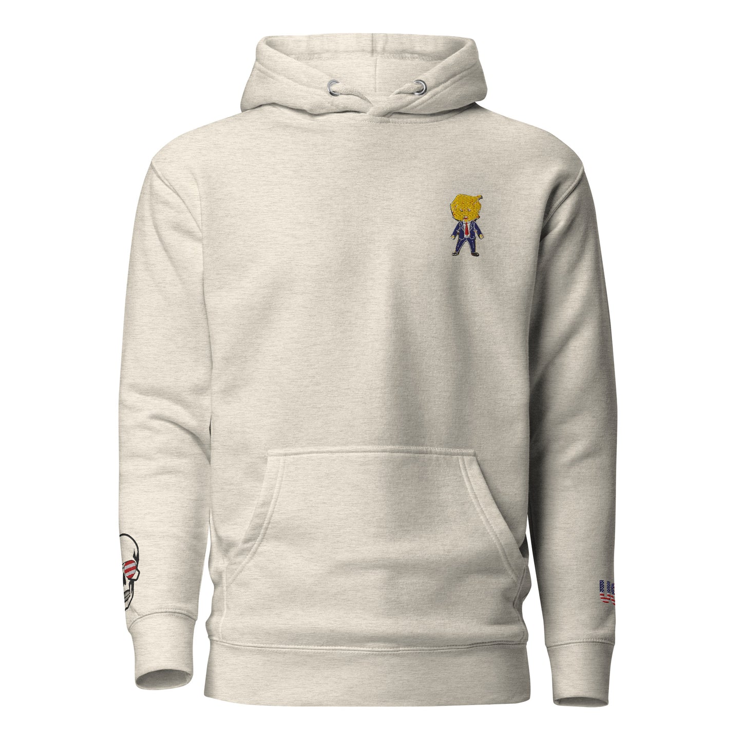 Front view of oatmeal heather hoodie with embroidered cartoon Happy Trump on chest, skull US flag on left sleeve