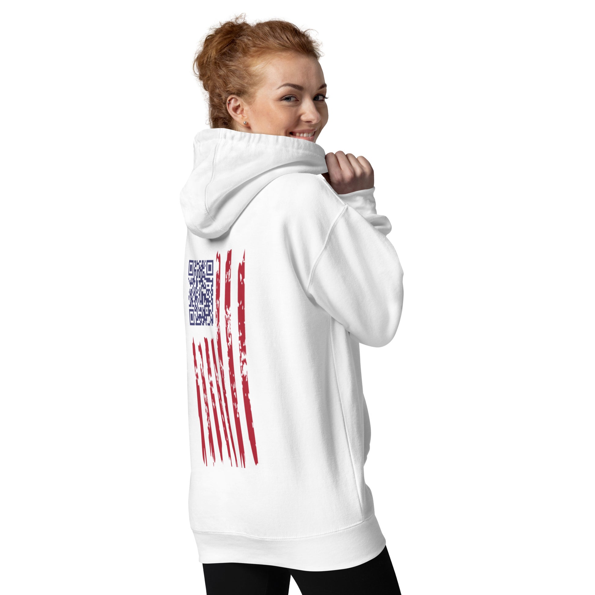 Redhead model grinning over shoulder in white hoodie, side angle showing back's embroidered QR flag