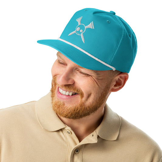 Smiling bearded model in front view of turquoise golf rope cap with white crossed-clubs skull embroidery