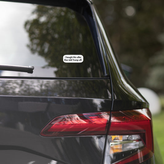 Lifestyle view of "I bought this off Elon" white bubble sticker on black car's rear window, Musk vibes on point