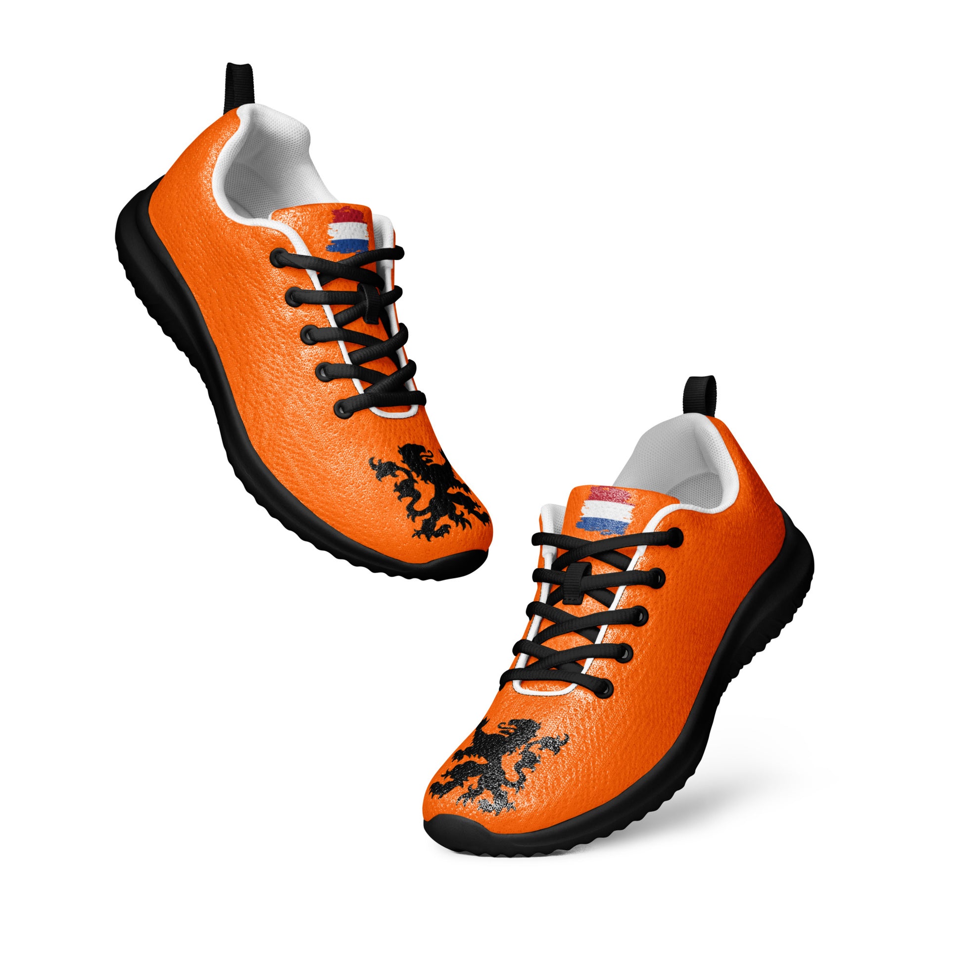 Overhead view of two orange flyknit sneakers with black lion emblems, white soles and laces visible
