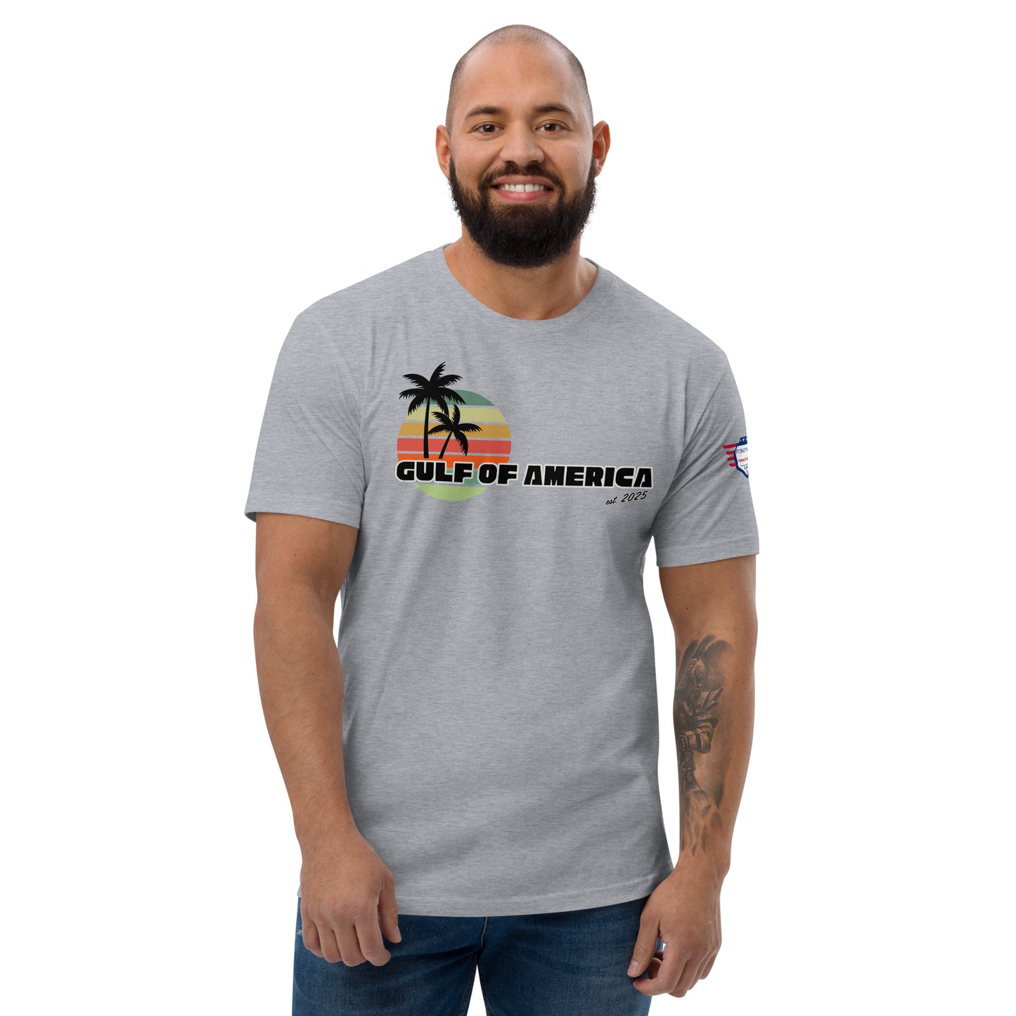 Front view of smiling bearded model in heather gray fitted Gulf of America tee, colorful palm sunset graphic