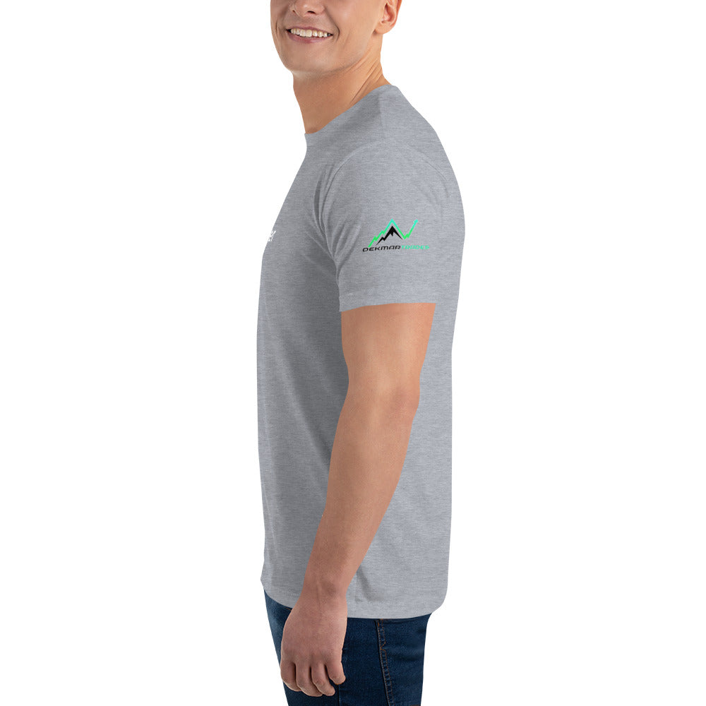 Close side view highlighting green mountain logo on sleeve of heather grey TradeCaster tee on model