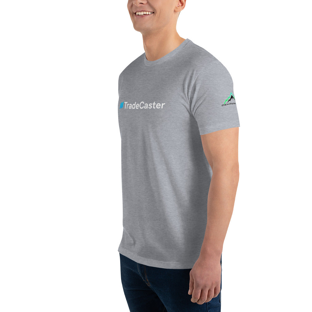 3/4 right-side view of model in heather grey fitted tee showing "#TradeCaster" front and green mountain sleeve logo