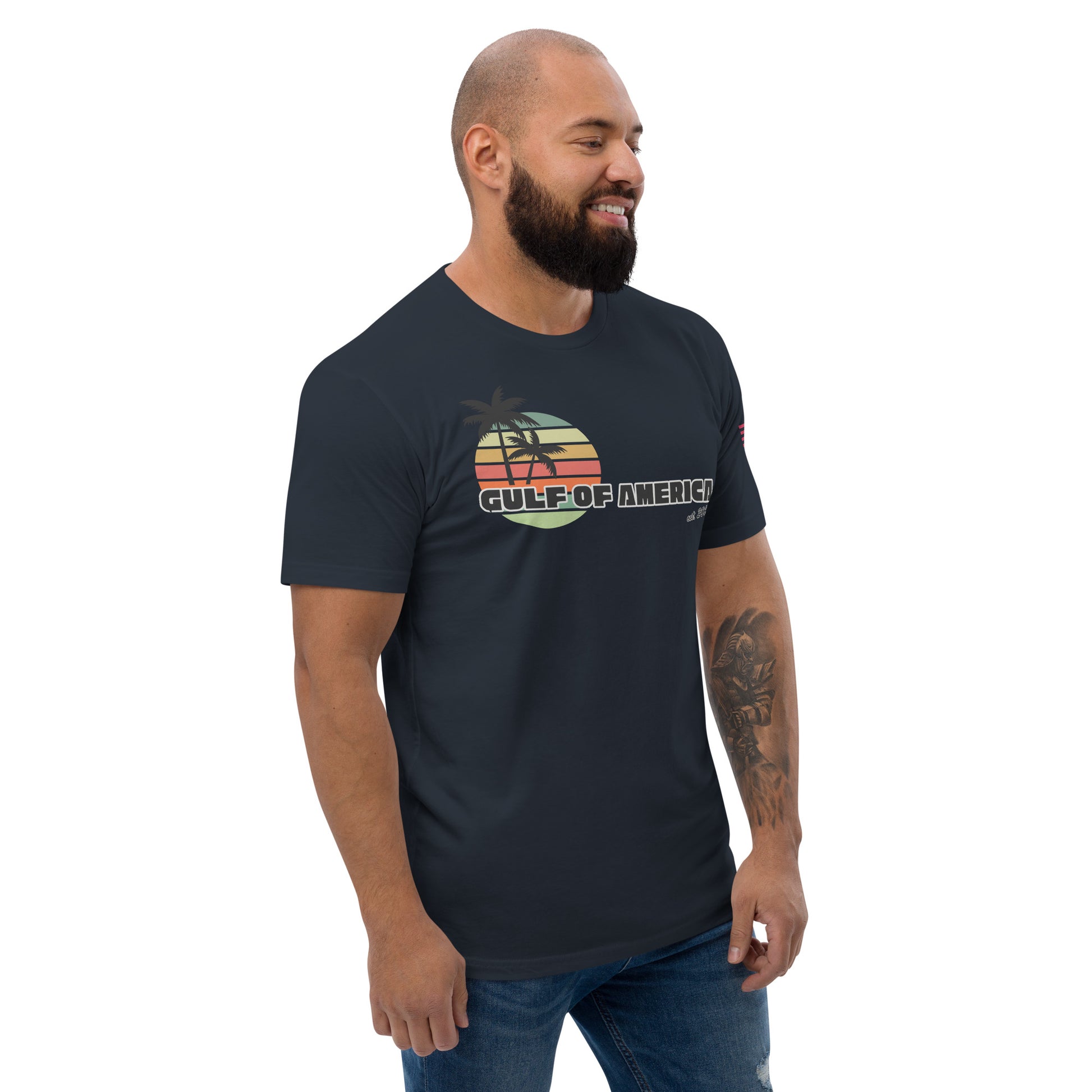 Left side view of grinning model in midnight navy fitted tee, edge of retro sunset design