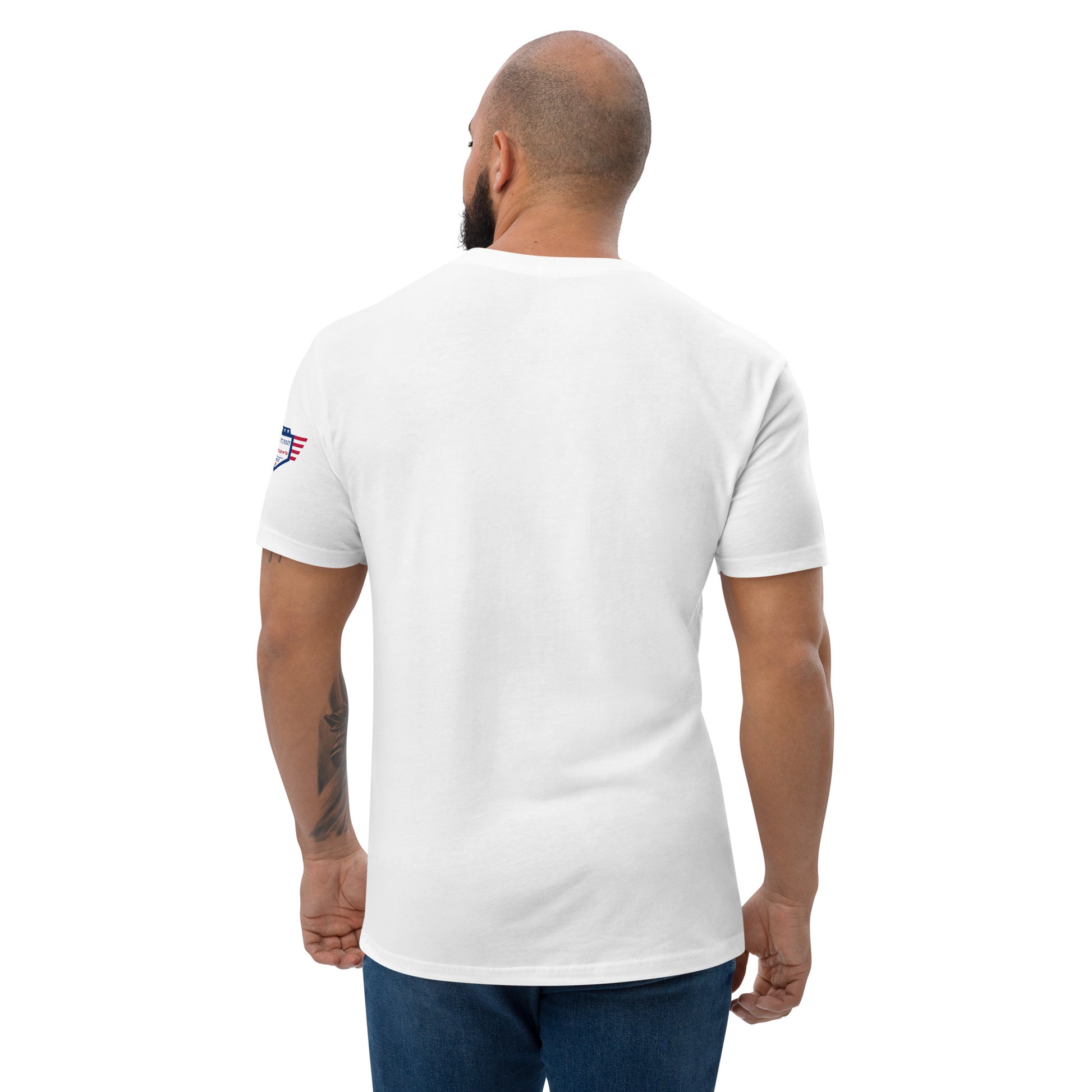 Back view of bearded model in plain white fitted shirt, small American flag patch on sleeve