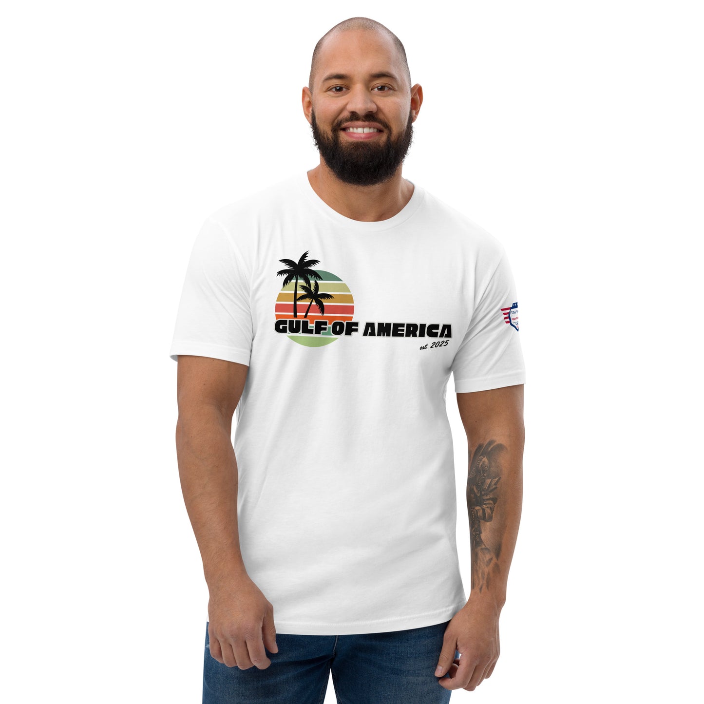 Front view of smiling bearded model in white fitted Gulf of America tee, retro palm tree sunset graphic and "est. 1776" text