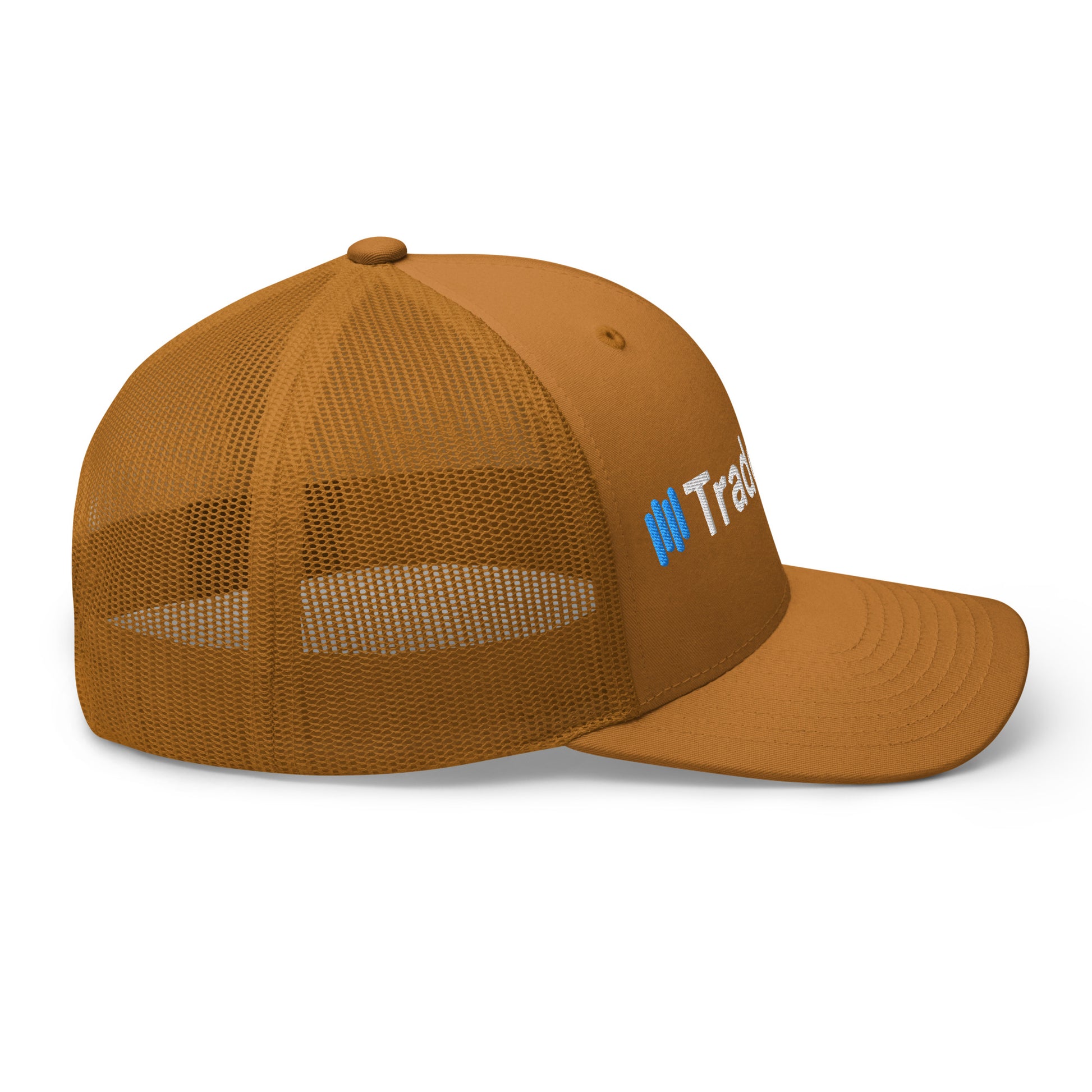 Front-right angle of caramel TradeCaster trucker cap, crisp white text with blue accents on earthy panels