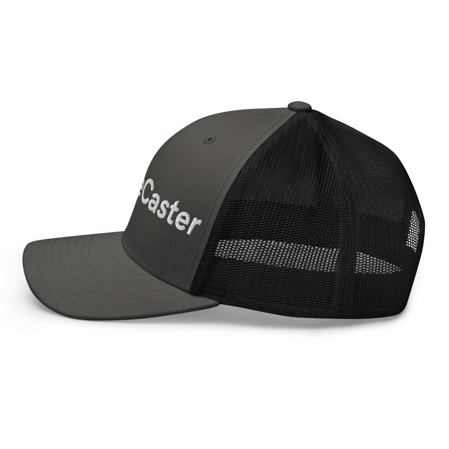 Right side view of dark gray/black mesh trucker cap, partial "TradeCaster" 3D puff embroidery visible, curved visor