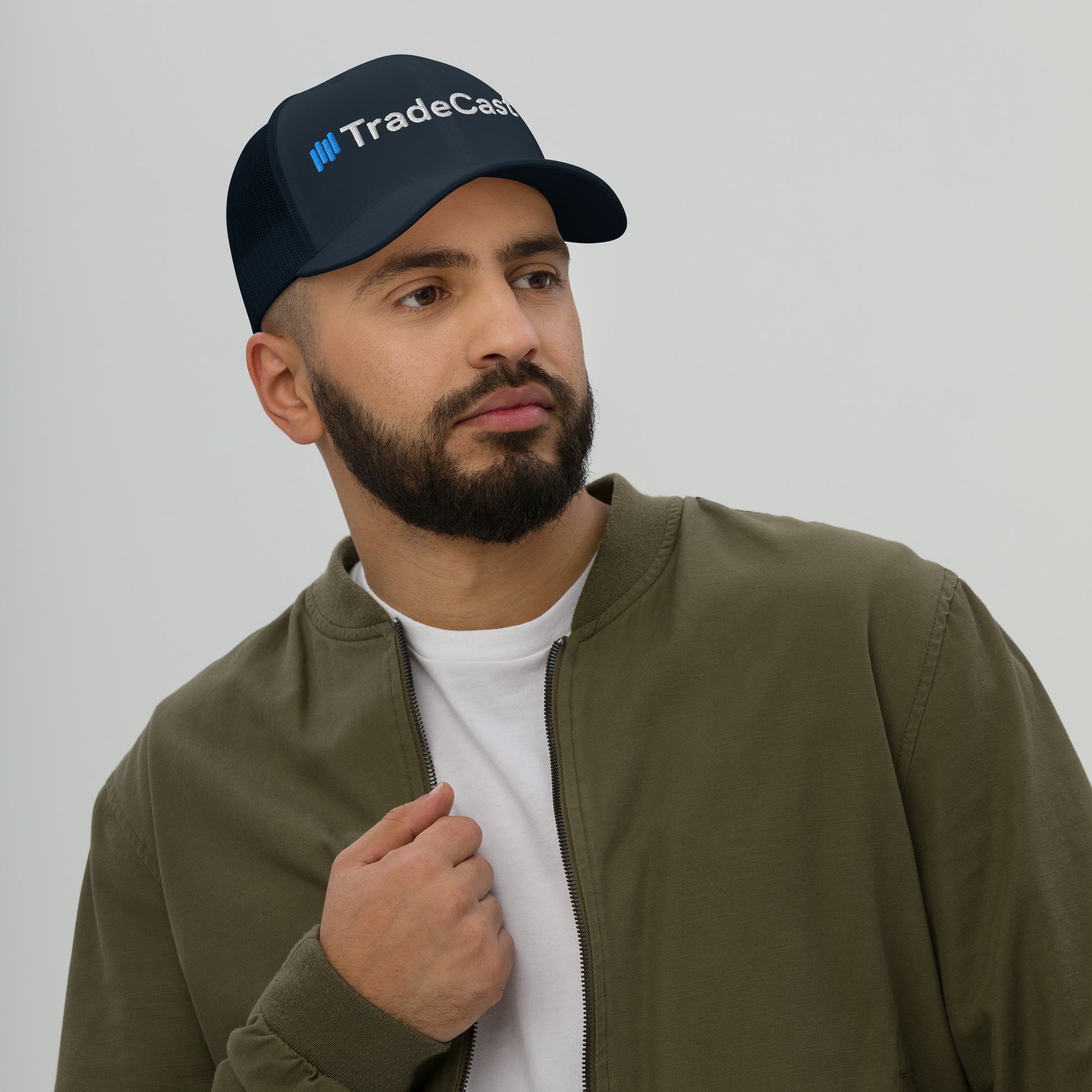 Navy TradeCaster trucker cap side profile on guy, hard buckram front holding strong