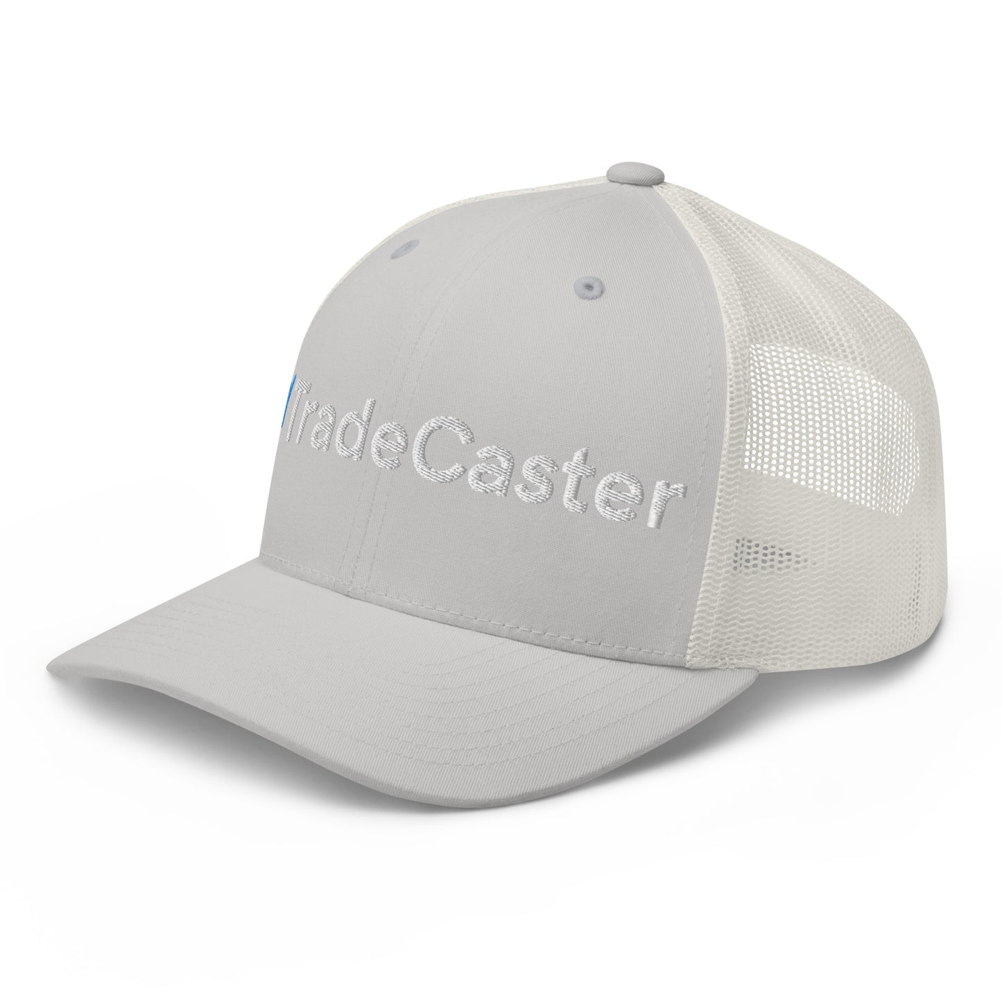 Left side view of gray trucker cap highlighting "Trade" 3D puff embroidery, transitioning to white mesh