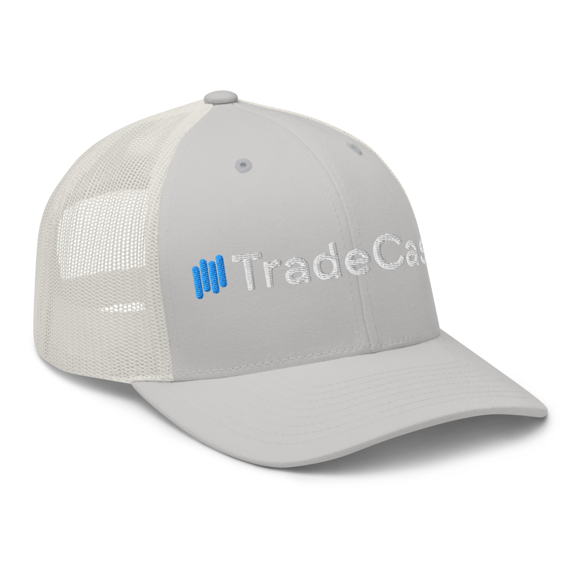 3/4 front-left angle on gray trucker cap, "Trade" 3D puff embroidery detail, white mesh rear