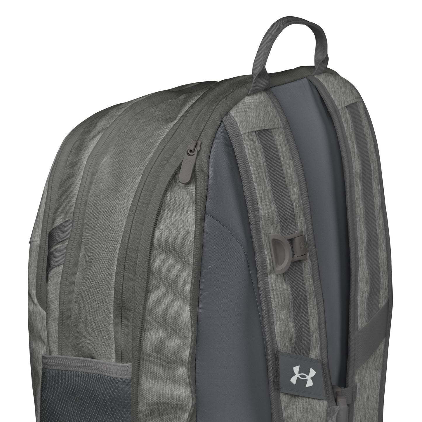 Right side view of heather gray Under Armour backpack showing padded straps, mesh pocket, and chest buckle
