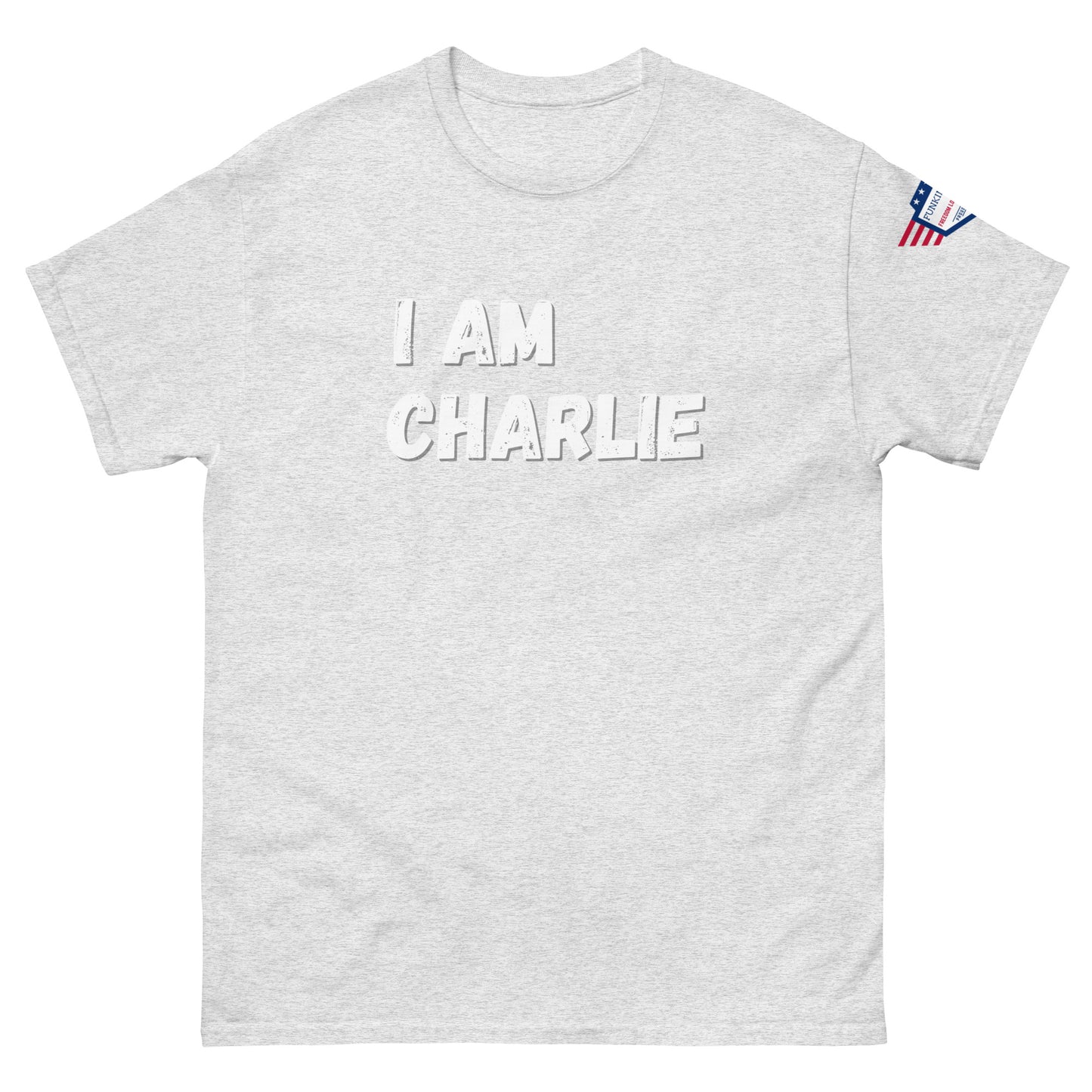 Front view of light gray unisex tee with bold white "I AM CHARLIE" print and small American flag sleeve patch