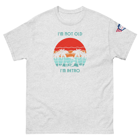 Front view of light gray unisex t-shirt with "I'm not old I'm retro" text and colorful palm sunset graphic, US flag sleeve patch