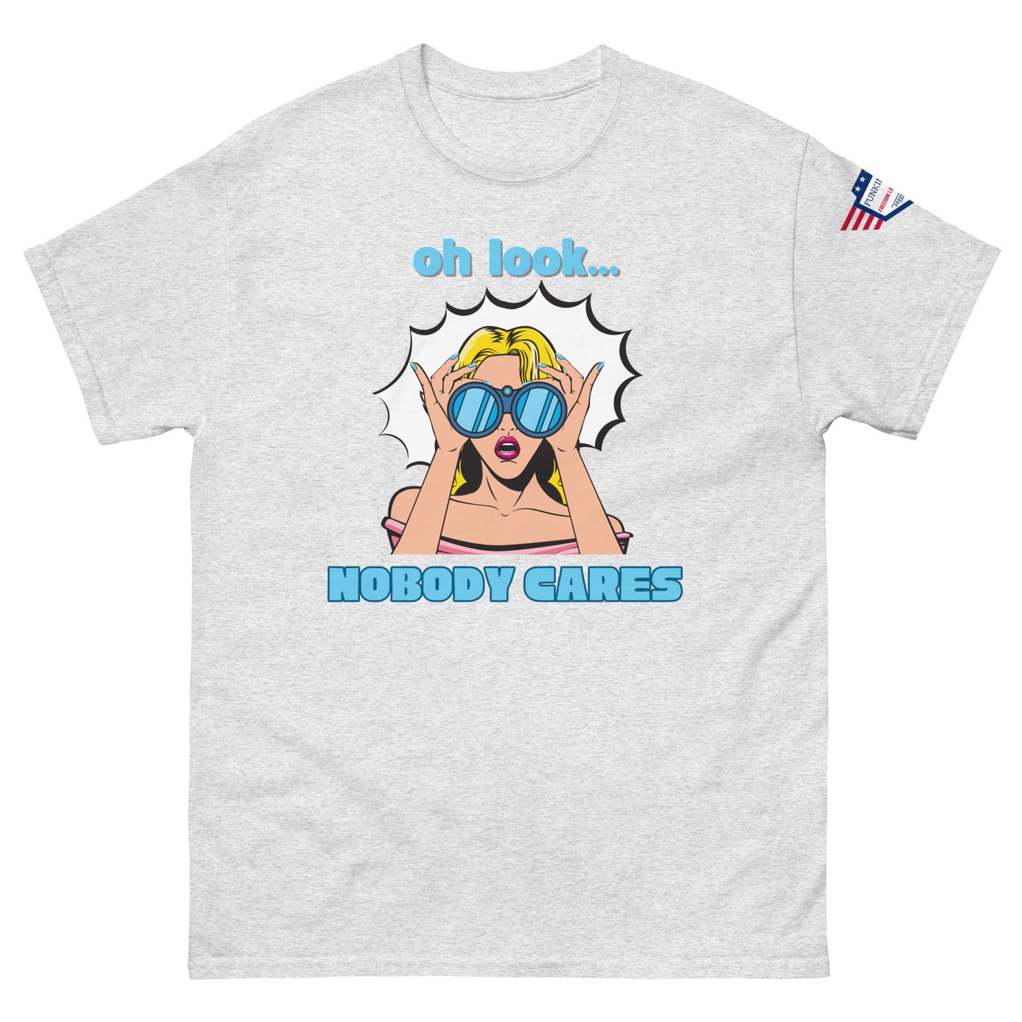 Front view of ash gray unisex t-shirt with cyan "Oh look..." text, pop-art blonde diva in blue shades yelling "NOBODY CARES", USA flag sleeve patch