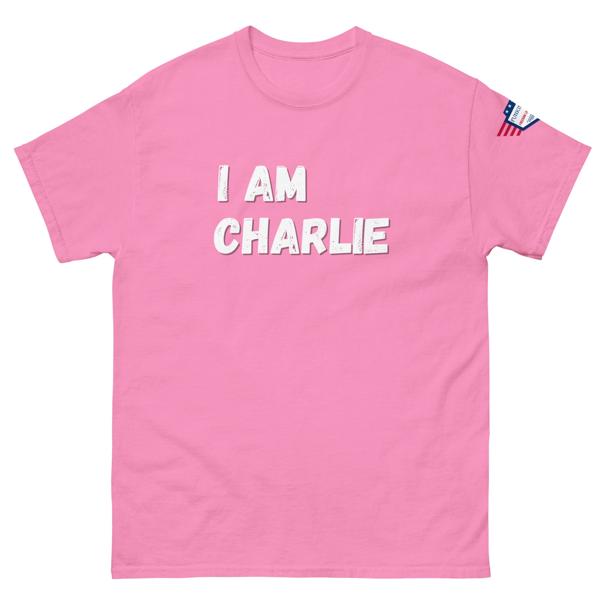 Front view of hot pink unisex tee with bold white "I AM CHARLIE" print and small American flag sleeve patch
