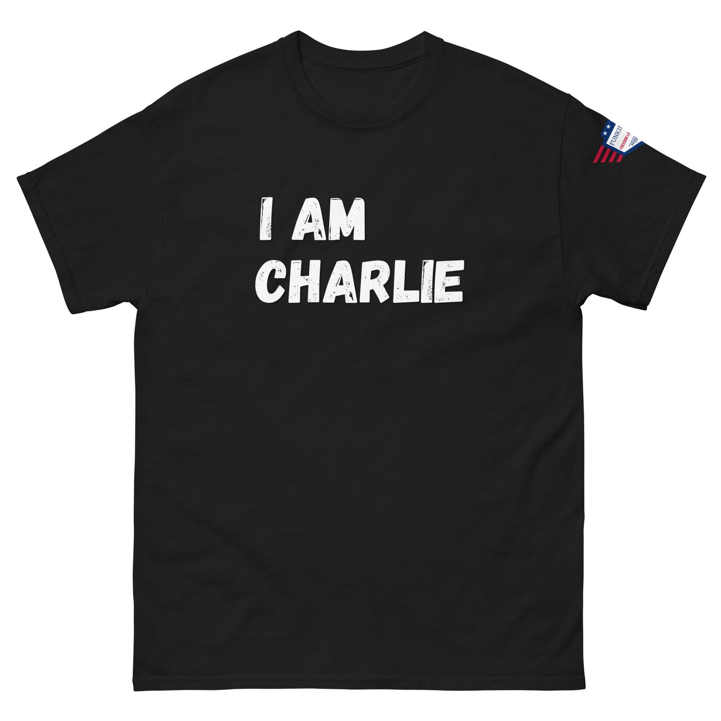 Front view of black unisex tee with bold white "I AM CHARLIE" print and small American flag sleeve patch