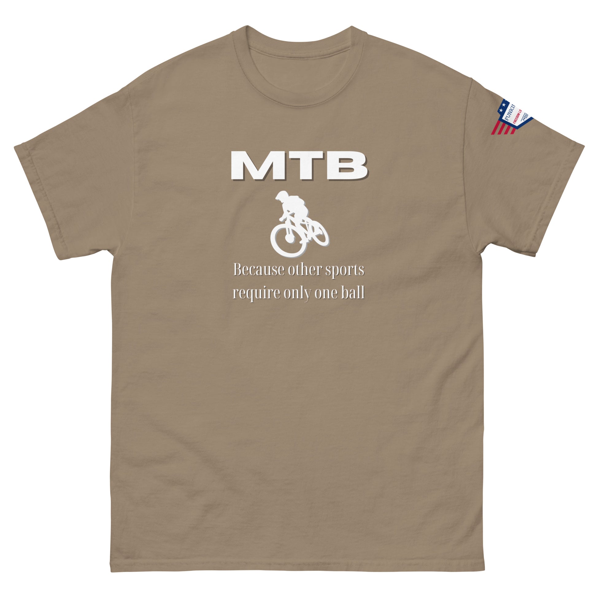 Front view of tan unisex t-shirt showing white "MTB" lettering, bike jumper icon, "Because other sports require only one ball", US flag sleeve
