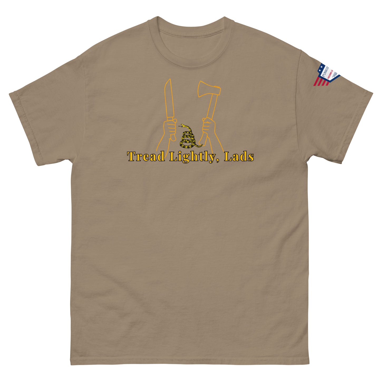 Front view of tan unisex tee with gold "Tread Lightly, Lads" print, hands gripping knife & axe around coiled Gadsden snake, US flag sleeve patch