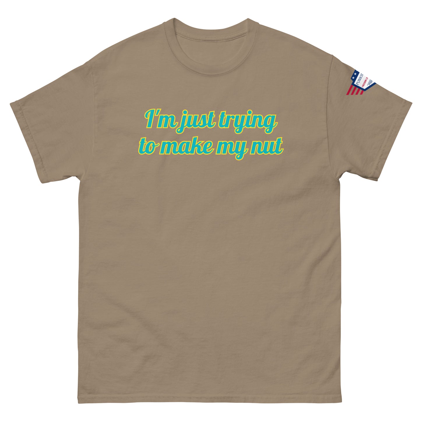 Front view of tan unisex tee featuring "I'm just trying to make my nut" in glowing teal font, flag patch