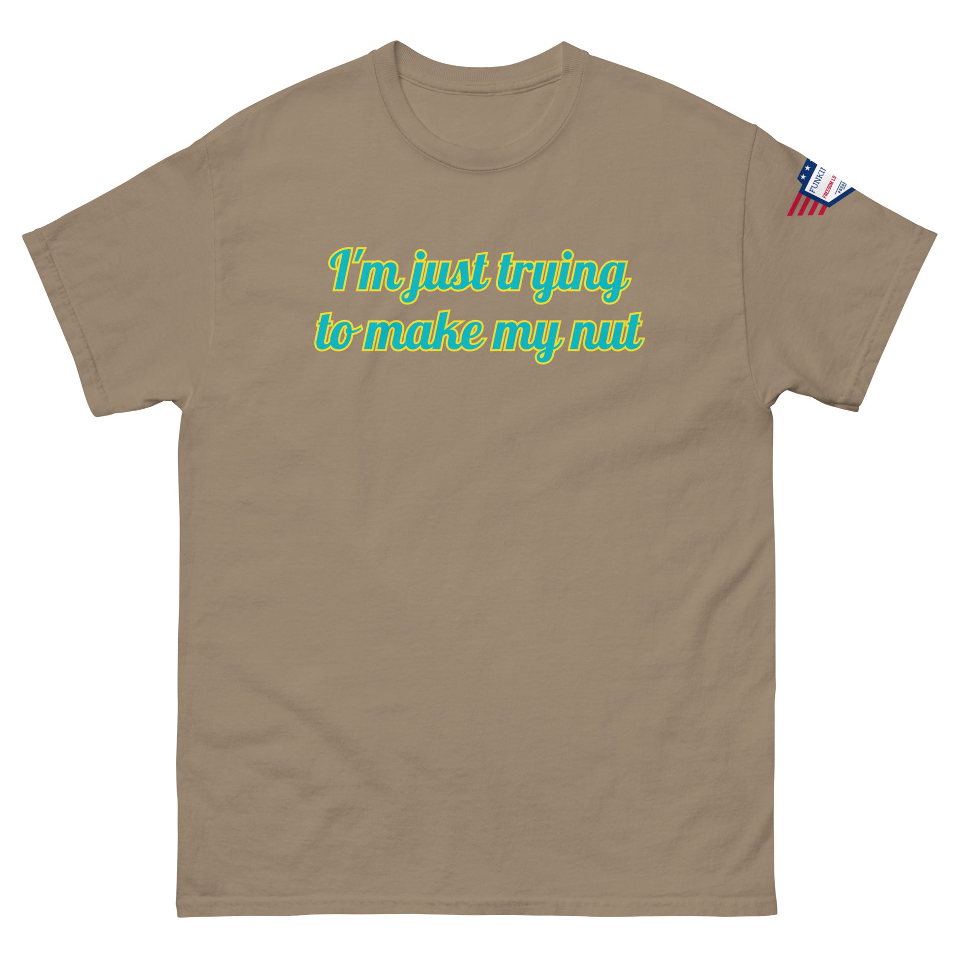 Front view of tan unisex tee featuring "I'm just trying to make my nut" in glowing teal font, flag patch