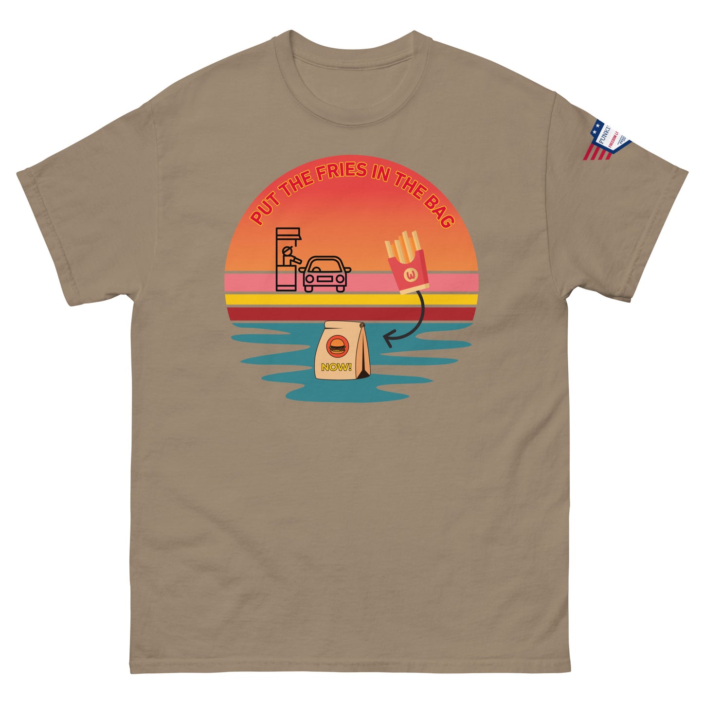 Front view of sand beige unisex T-shirt showing "Put the fries in the bag" vibrant drive-thru meme sunset design and flag patch