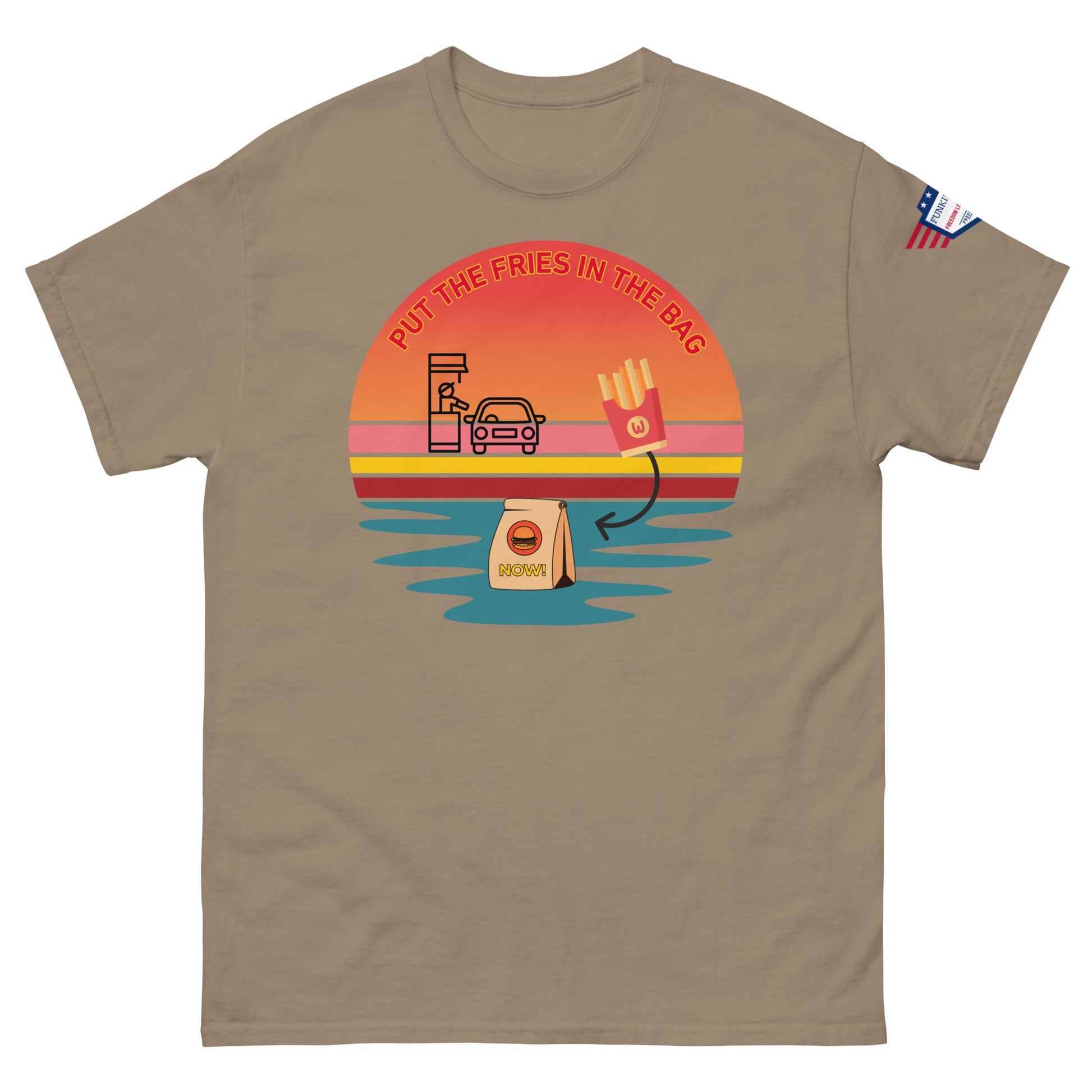 Front view of sand beige unisex T-shirt showing "Put the fries in the bag" vibrant drive-thru meme sunset design and flag patch