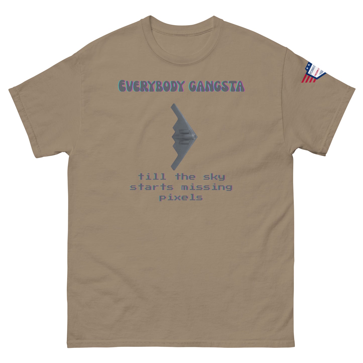 Front view of tan unisex tee with purple "Everybody Gangsta" text, gray stealth bomber graphic, teal "till the sky starts missing pixels" glitch print, flag sleeve patch