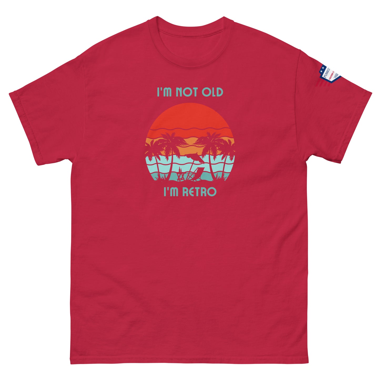 Front view of red unisex t-shirt with "I'm not old I'm retro" text and tropical sunset beach print, US flag on sleeve