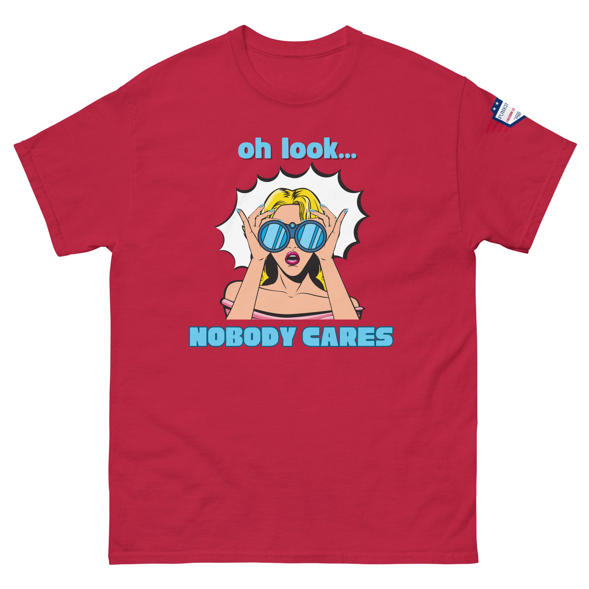 Front view of red unisex t-shirt with cyan "Oh look..." text, pop-art blonde diva in blue shades yelling "NOBODY CARES", USA flag sleeve patch