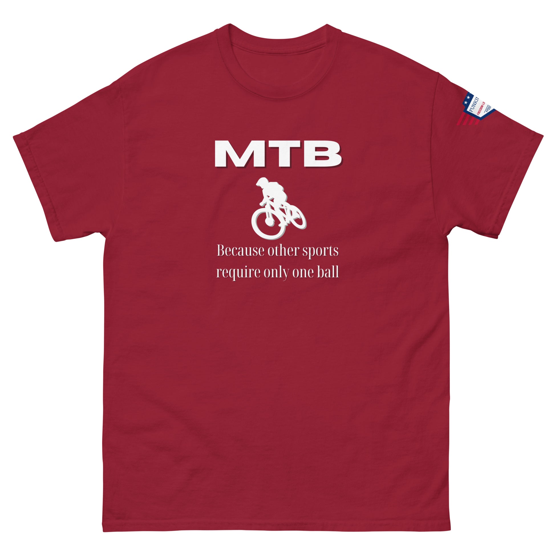 Front view of red unisex tee boasting white "MTB" logo, bike rider silhouette, "Because other sports require only one ball" slogan, flag patch