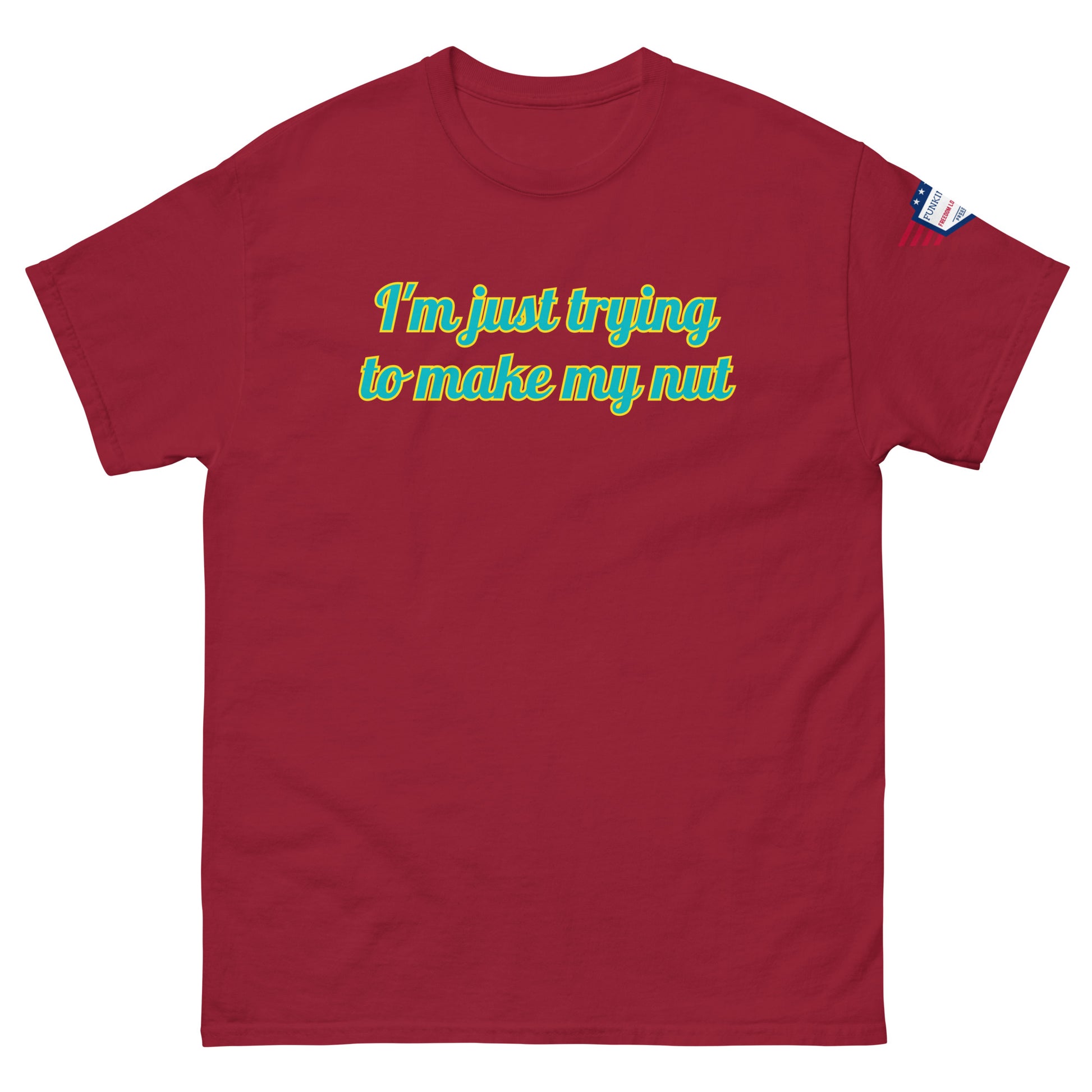 Front view of hot pink unisex tee with "I'm just trying to make my nut" in teal-yellow cursive print, US flag sleeve patch
