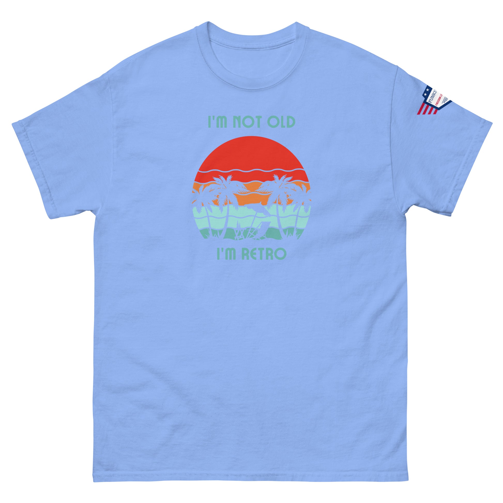 Front view of light blue unisex t-shirt boasting "I'm not old I'm retro" with retro sun, waves, palms design, flag patch