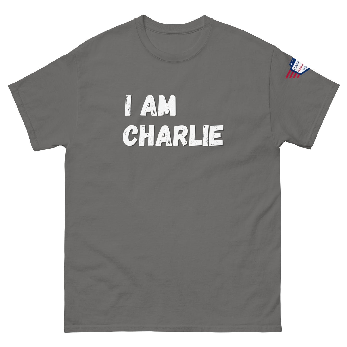 Front view of charcoal gray unisex tee with bold white "I AM CHARLIE" print and small American flag sleeve patch