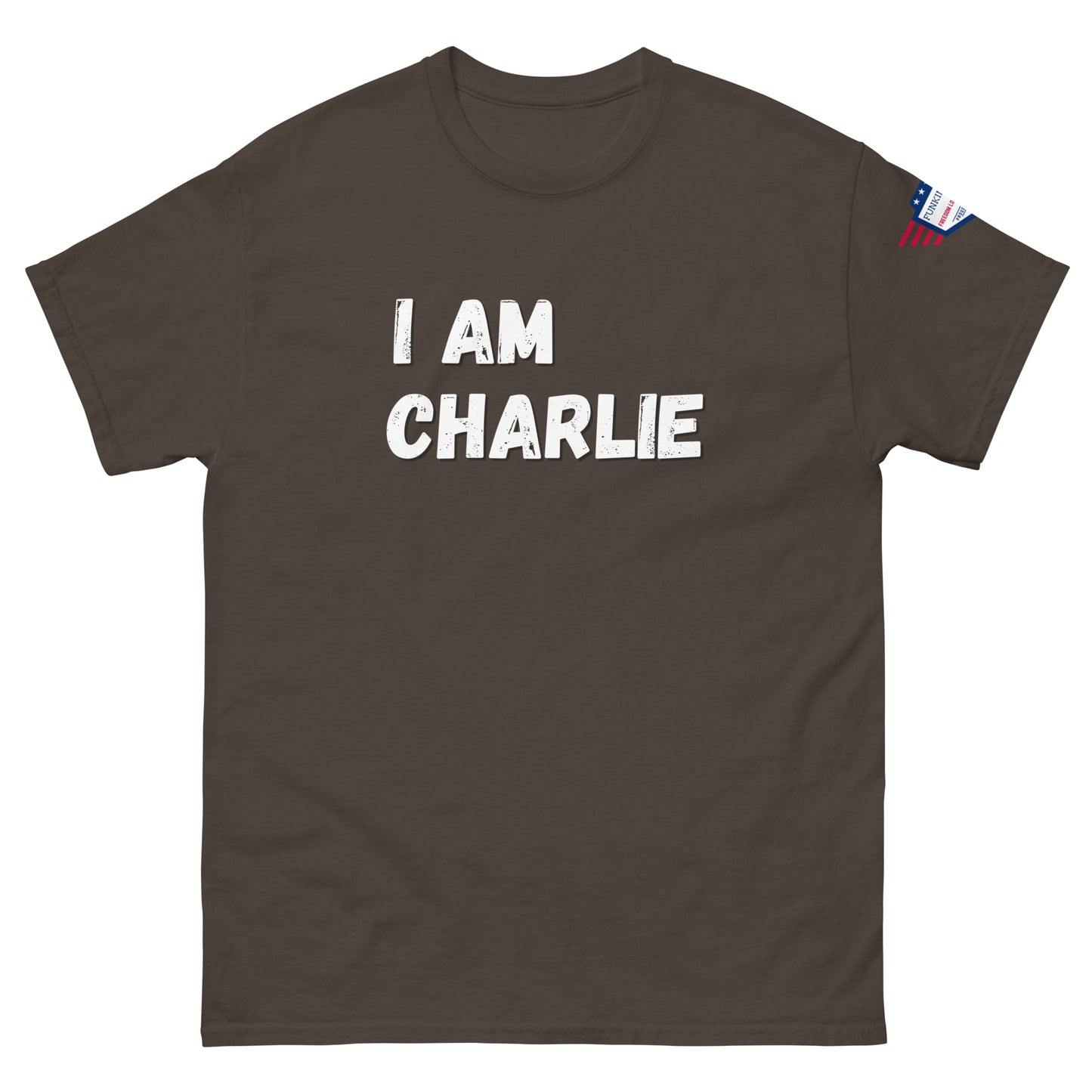 Front view of dark brown unisex tee with bold white "I AM CHARLIE" print and small American flag sleeve patch