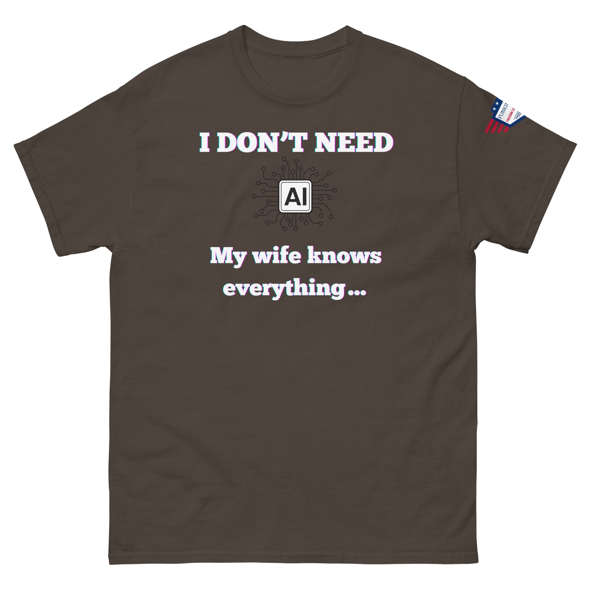 Front view of brown unisex tee with glowing "I DON'T NEED" over AI circuit icon, "My wife knows everything..." below, flag sleeve patch