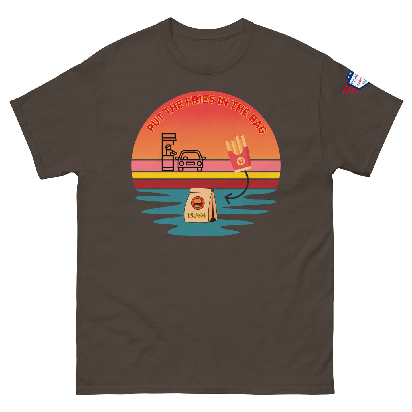Front view of dark brown unisex T-shirt with "Put the fries in the bag" vibrant sunset drive-thru print and flag sleeve patch