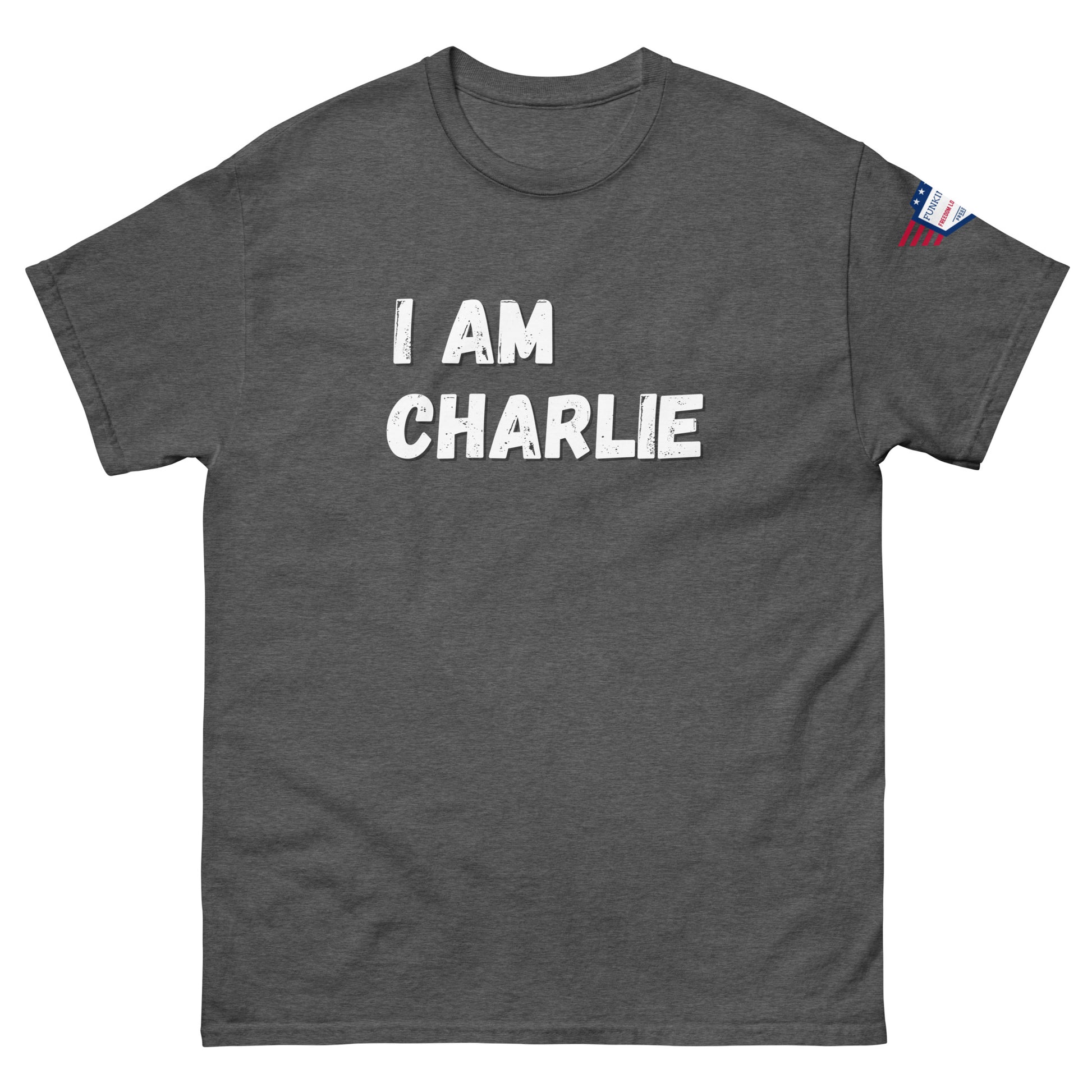 Front view of heather gray unisex tee with bold white "I AM CHARLIE" print and small American flag sleeve patch
