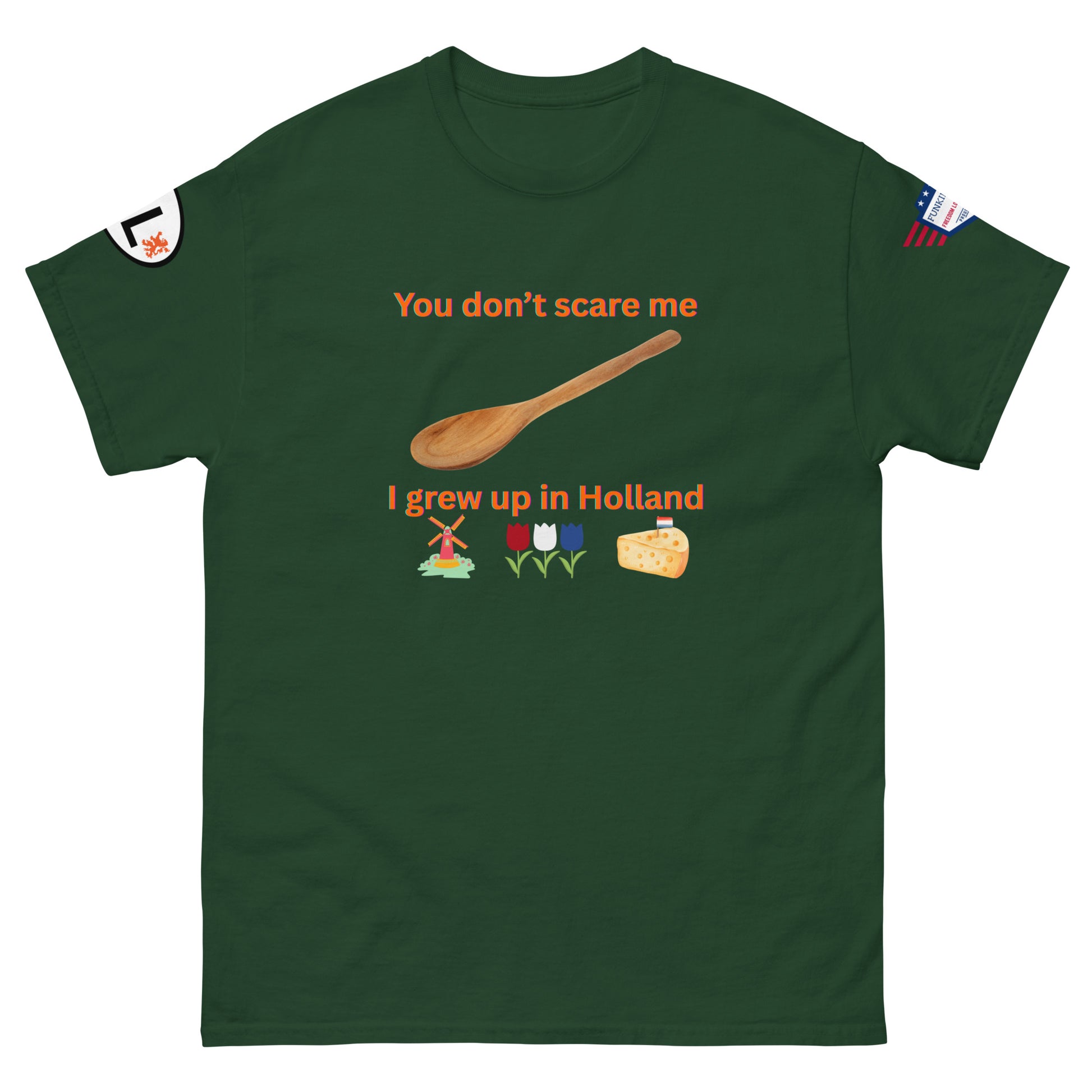 Front view of forest green unisex tee showing "You don't scare me I grew up in Holland" print, wooden spoon, windmill, tulips, cheese emojis, arm labels