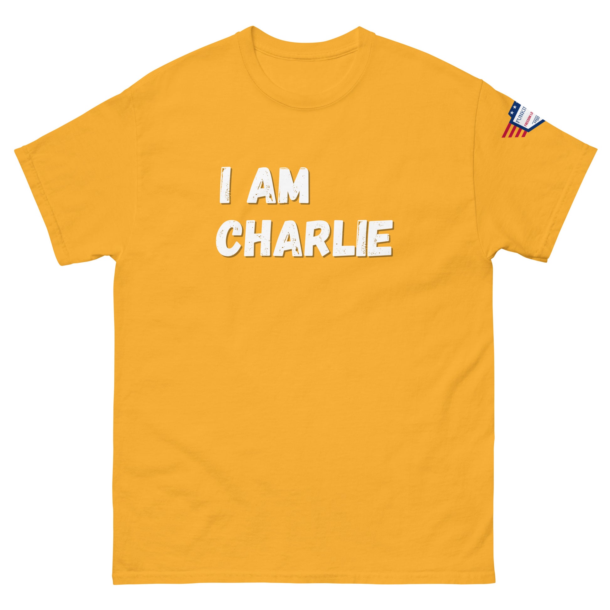 Front view of bright yellow unisex tee with bold white "I AM CHARLIE" print and small American flag sleeve patch