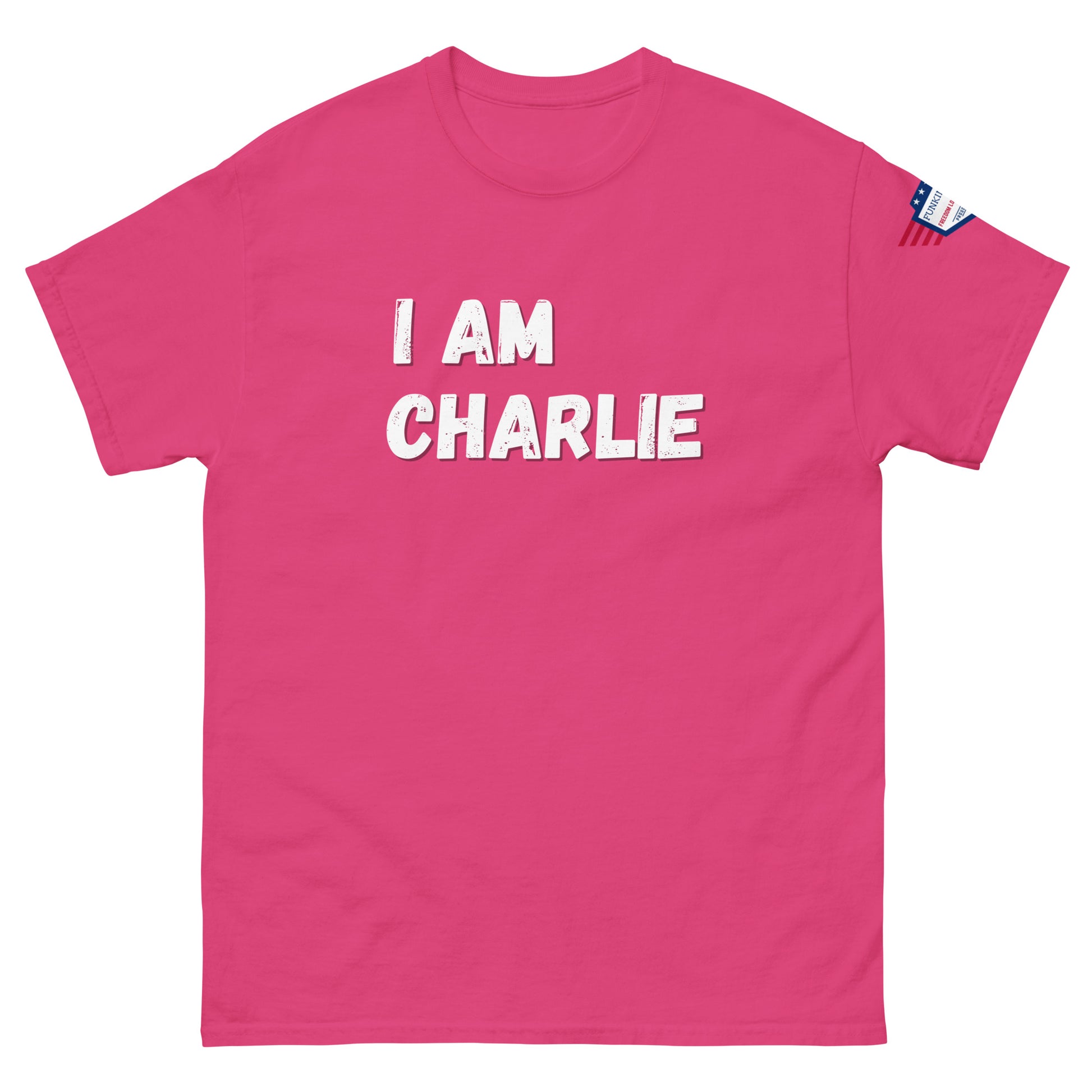 Front view of hot pink unisex tee with bold white "I AM CHARLIE" graphic and USA flag sleeve patch