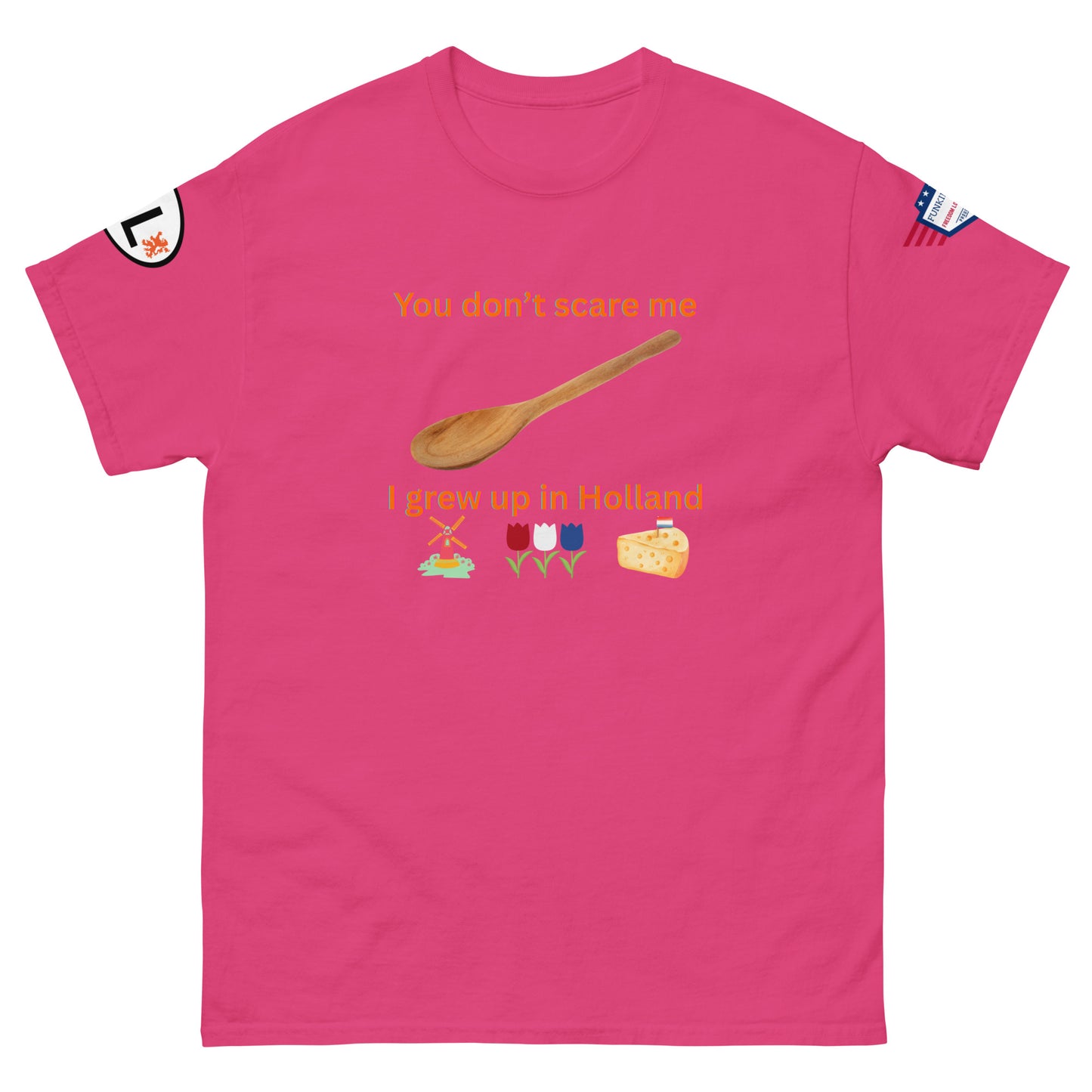 Front view of hot pink unisex tee displaying "You don't scare me I grew up in Holland" orange print, spoon, windmill, tulips, cheese emojis, sleeve patches