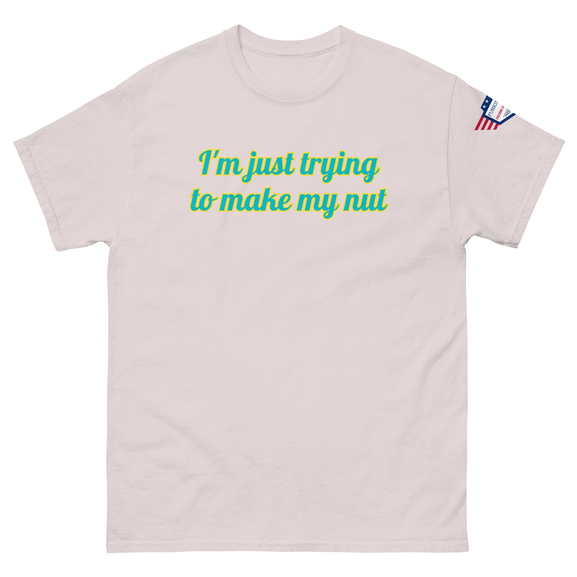 Front view of light ash unisex tee with "I'm just trying to make my nut" in teal-yellow cursive print, US flag sleeve patch