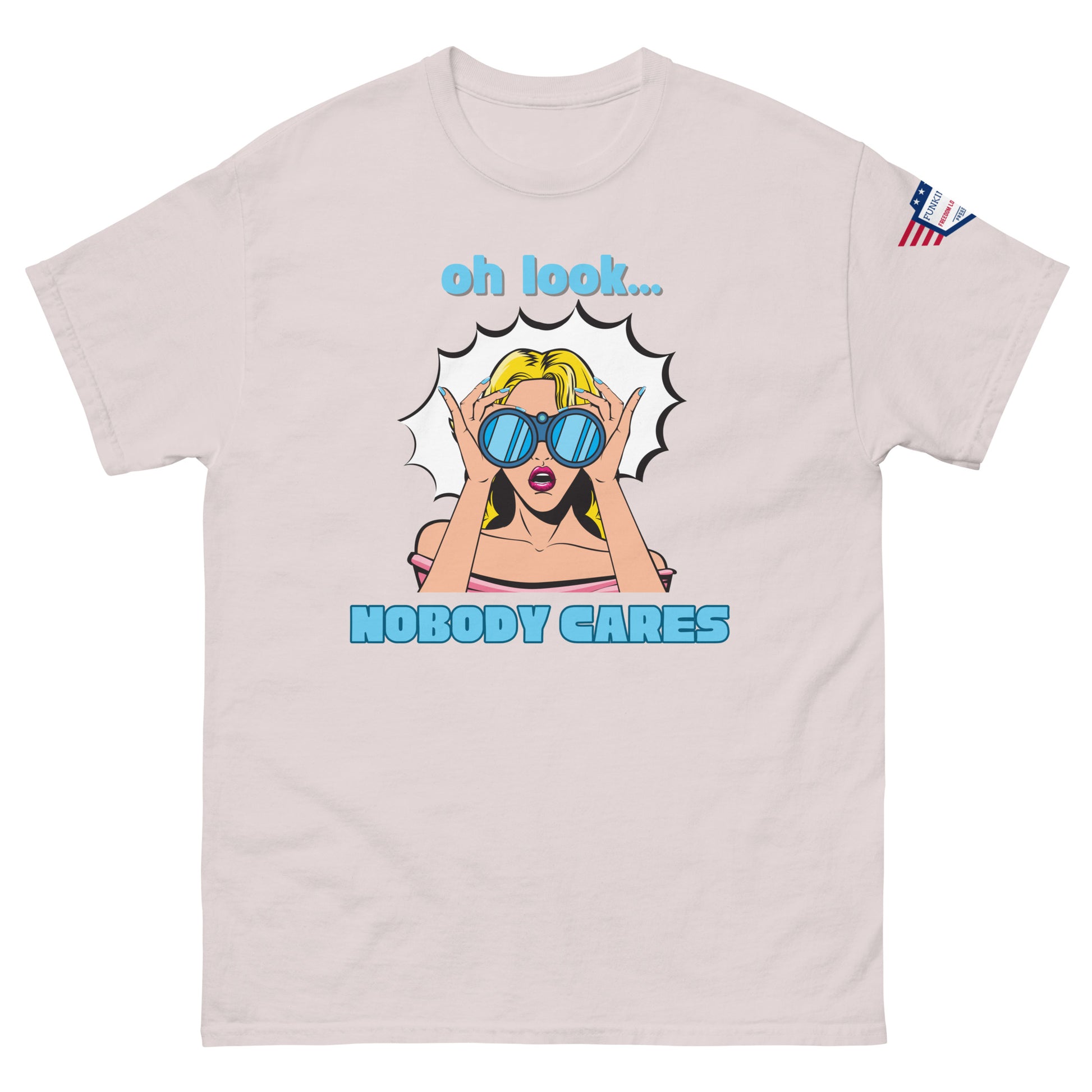 Front view of light ash unisex t-shirt showing "oh look... NOBODY CARES" sassy comic print and USA sleeve patch