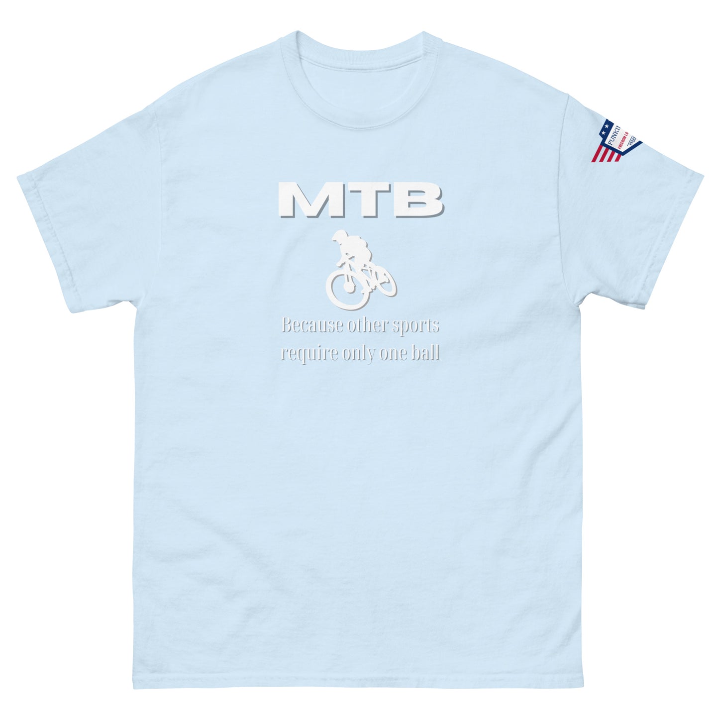 Front view of light blue unisex tee with bold white "MTB" text, biker silhouette, "Because other sports require only one ball" print, flag sleeve patch