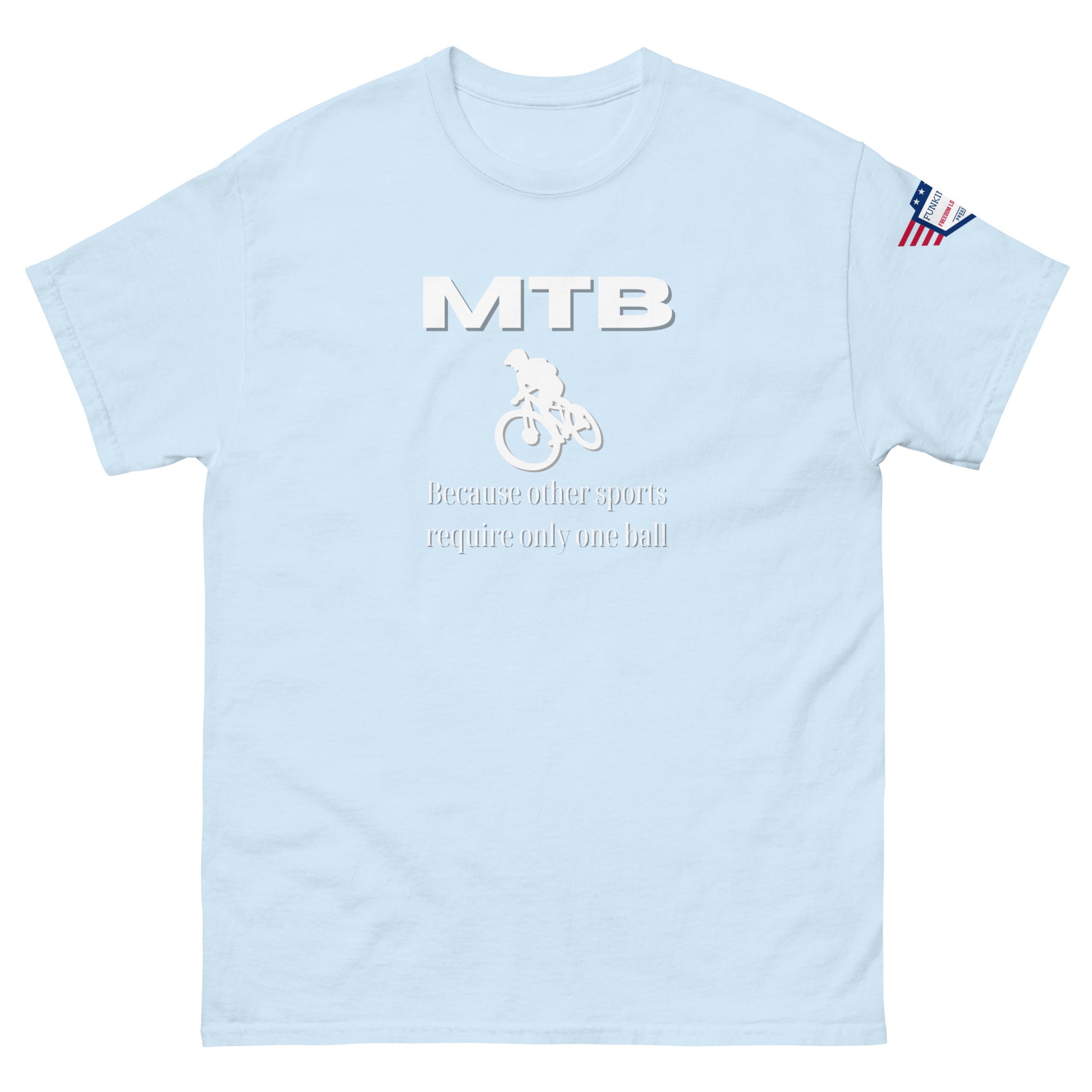 Front view of light blue unisex tee with bold white "MTB" text, biker silhouette, "Because other sports require only one ball" print, flag sleeve patch